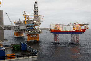 Oil climbs more than 4% as OPEC+ agrees record output cut